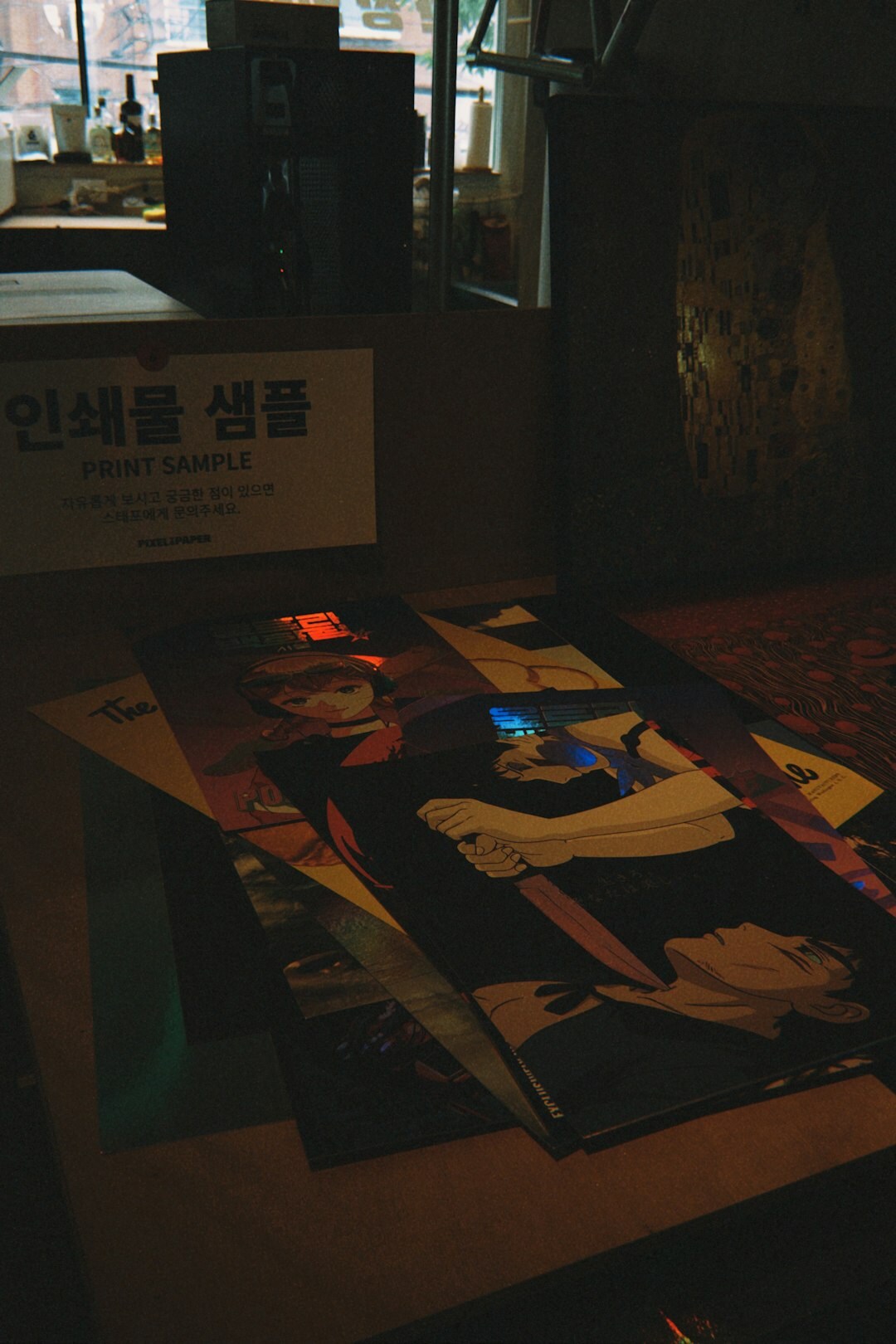 Light table with printed advertisement layouts and a magnifying loupe